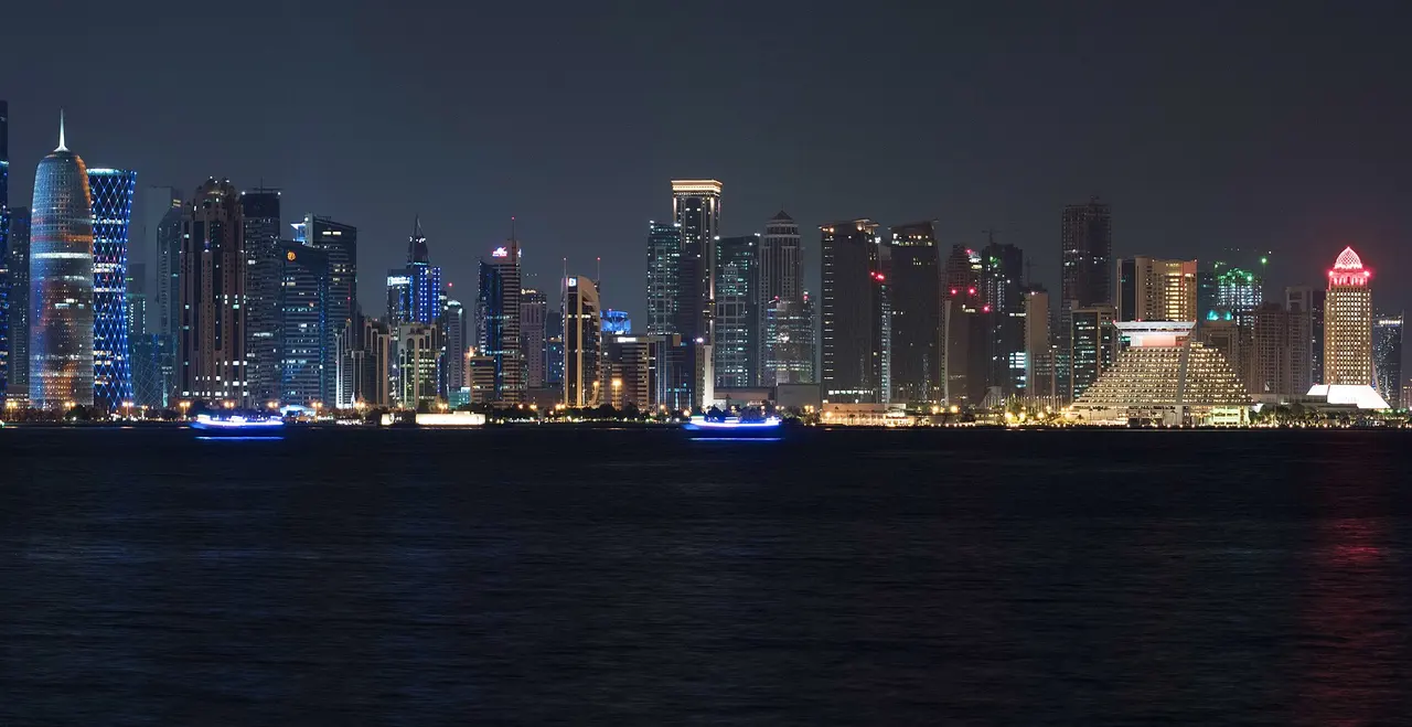 The West Bay skyline lit at night across Doha Bay