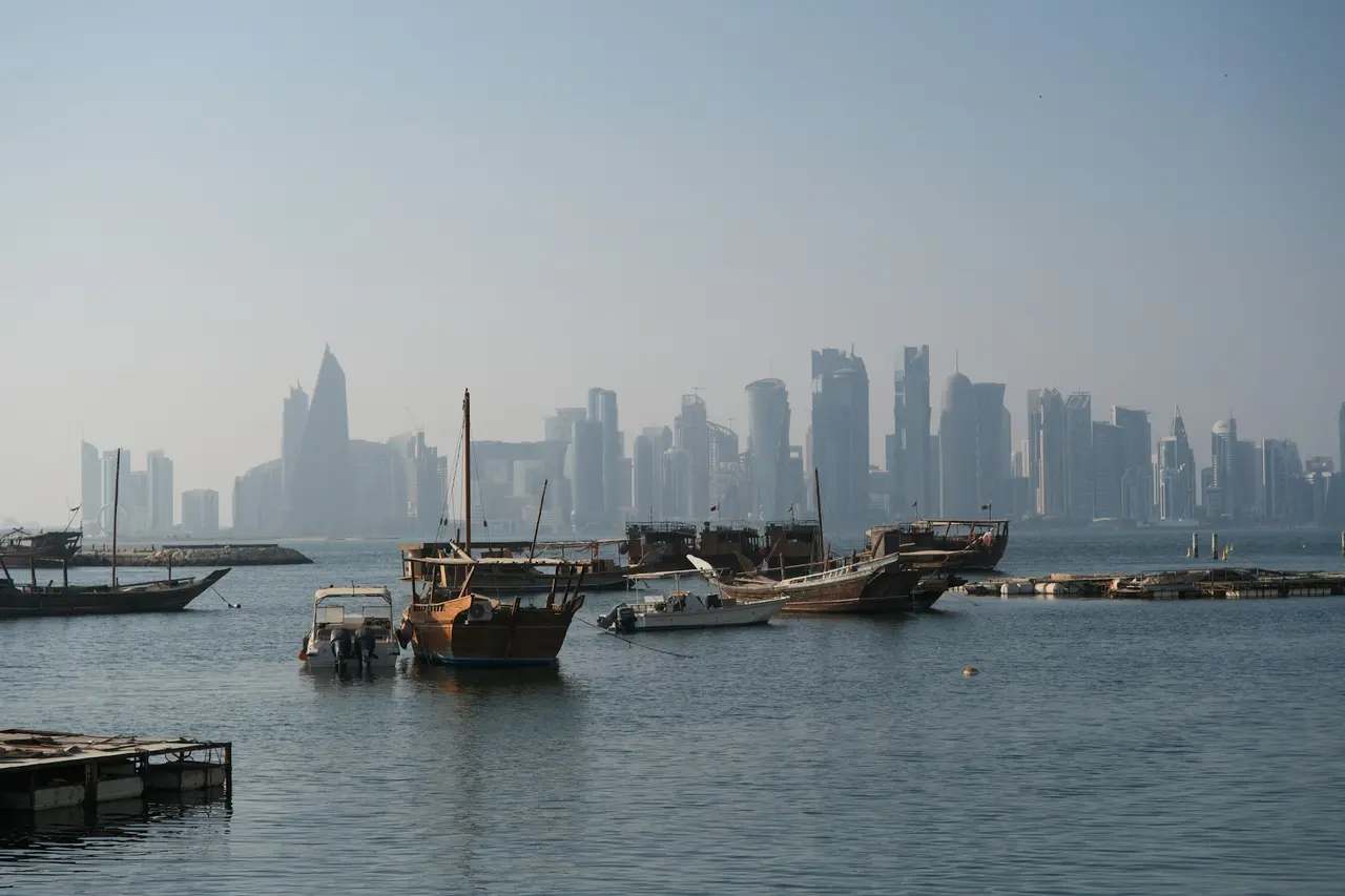 Trading dhows moored in Doha harbour with the West Bay skyline behind