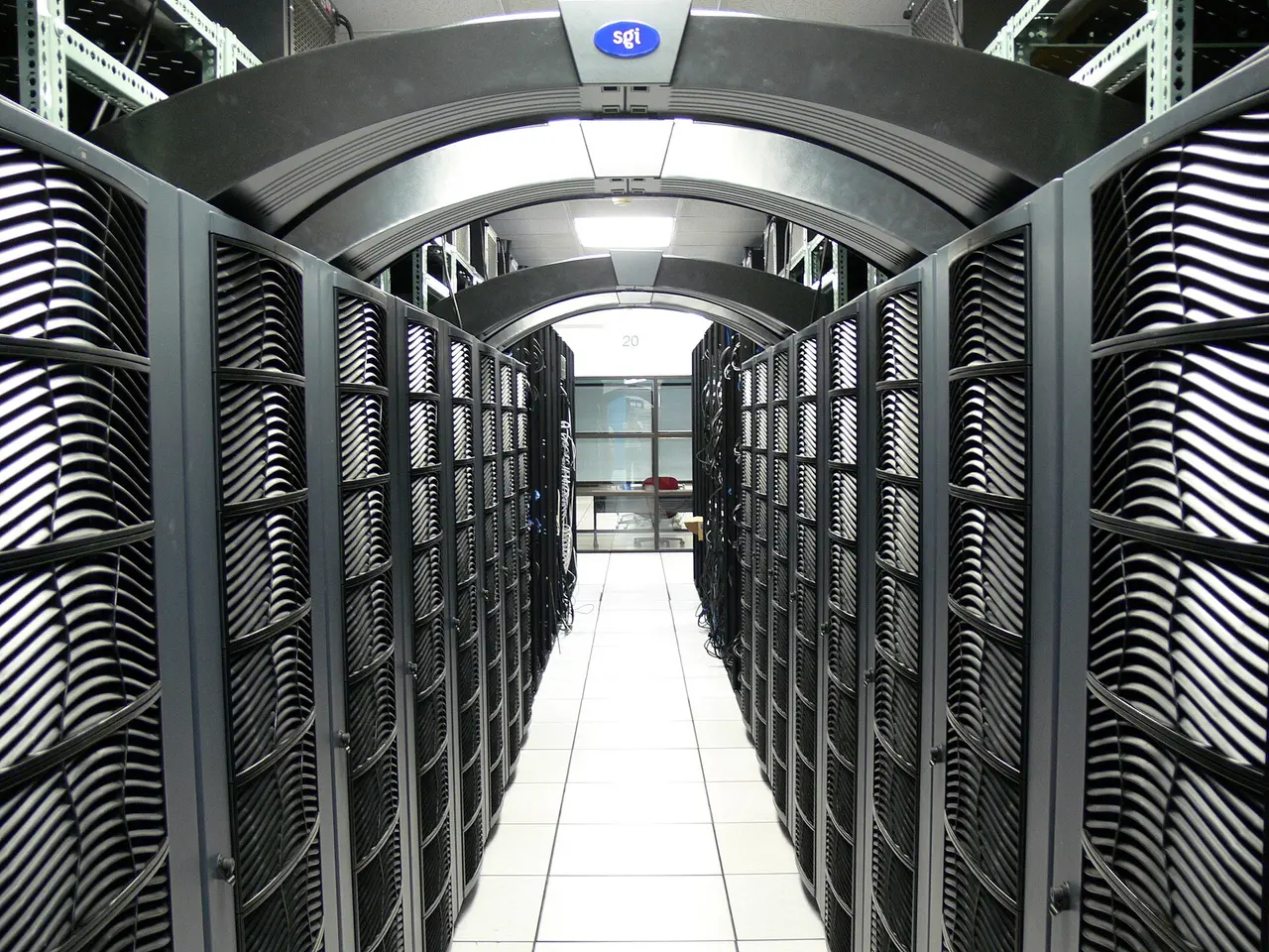 A long aisle between rows of servers in a data centre