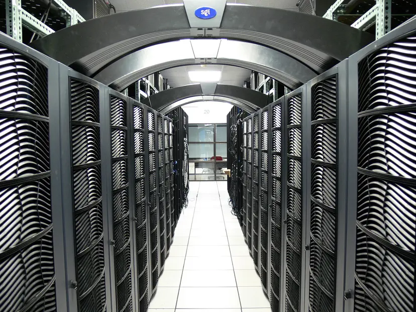 A long aisle between rows of servers in a data centre
