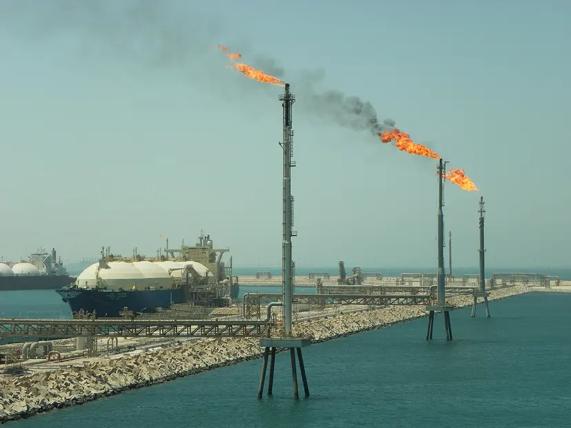 Gas flares and an LNG carrier at the Ras Laffan terminal, Qatar