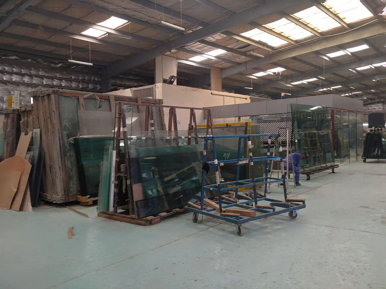 Sheets of glass on racks inside a glass workshop in the Doha Industrial Area