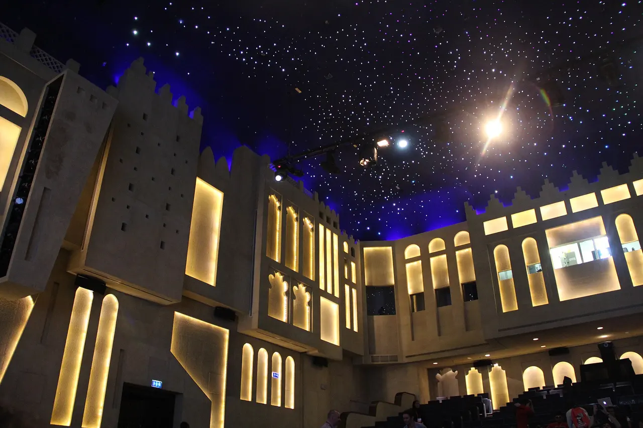 The lit stone walls of the Katara Drama Theatre in Katara Cultural Village