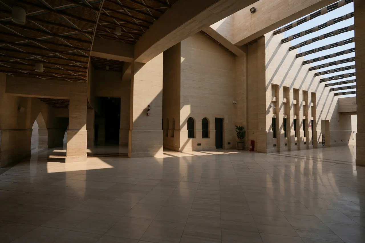 A stone hall lit by a slatted skylight at Katara Cultural Village, Doha