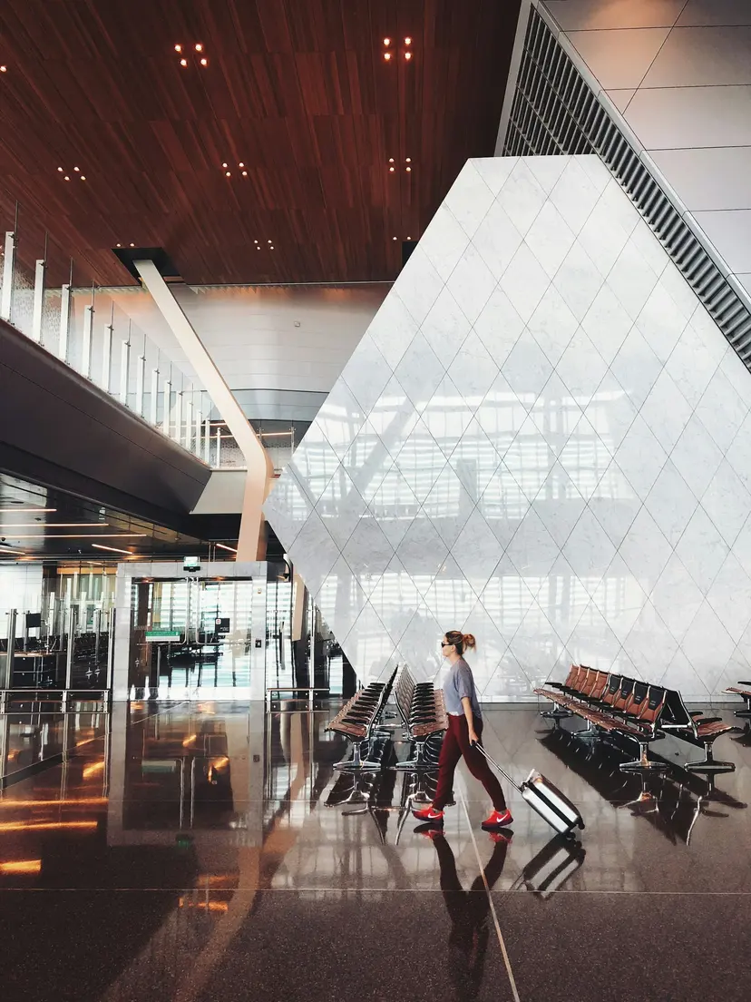 A traveller walking through Hamad International Airport, Doha