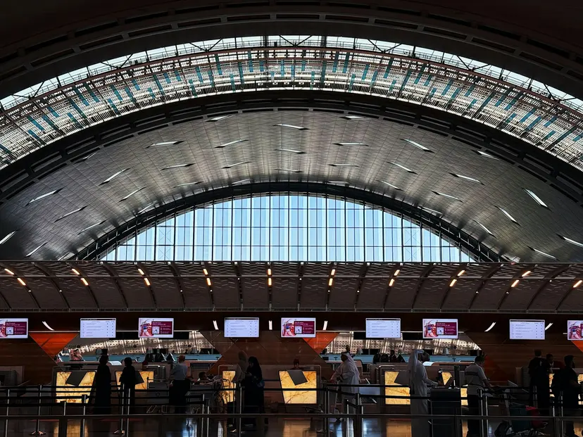 Check-in counters under the arched roof of Hamad International Airport