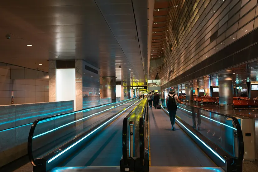 A traveller on a moving walkway at Hamad International Airport