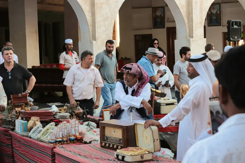 Traders and shoppers around an antiques stall in Souq Waqif