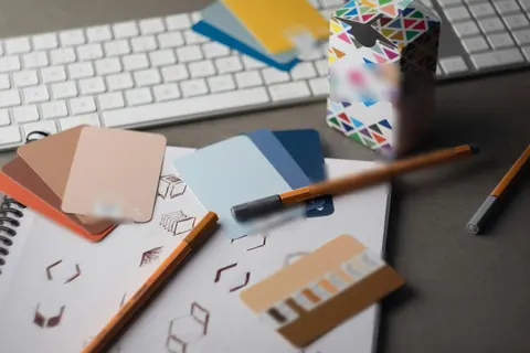 Colour samples, pencils and logo sketches on a designer’s desk