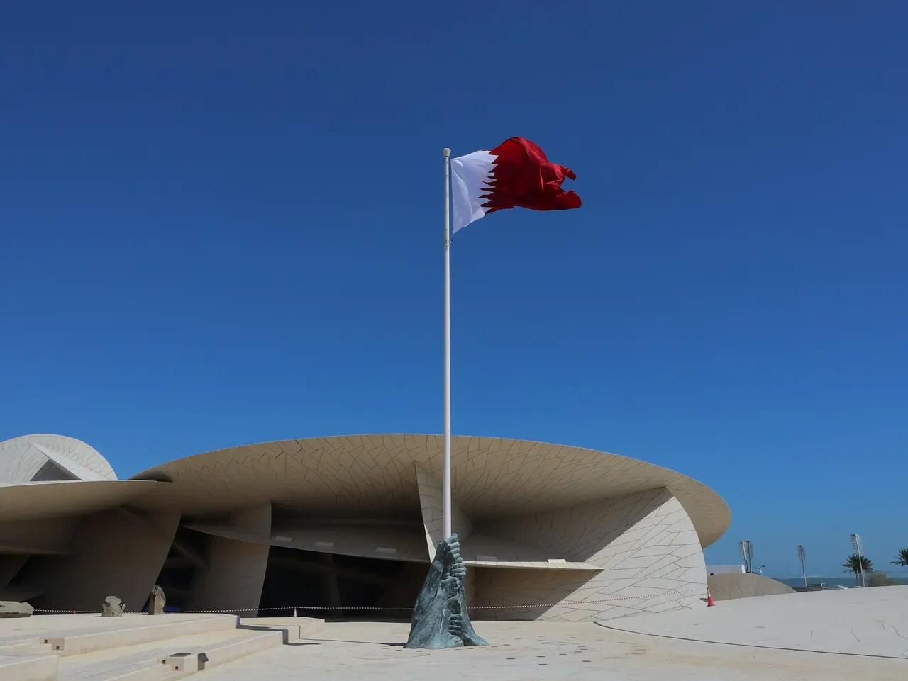 The Qatar flag flying over the National Museum of Qatar in Doha