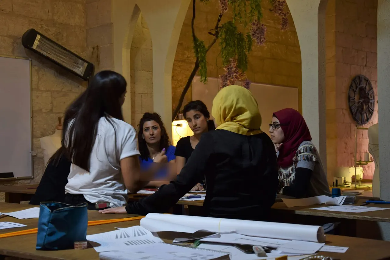 Women founders discussing plans around a workshop table