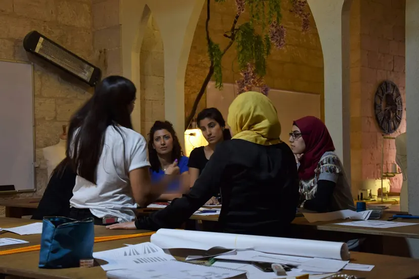 Women founders discussing plans around a workshop table